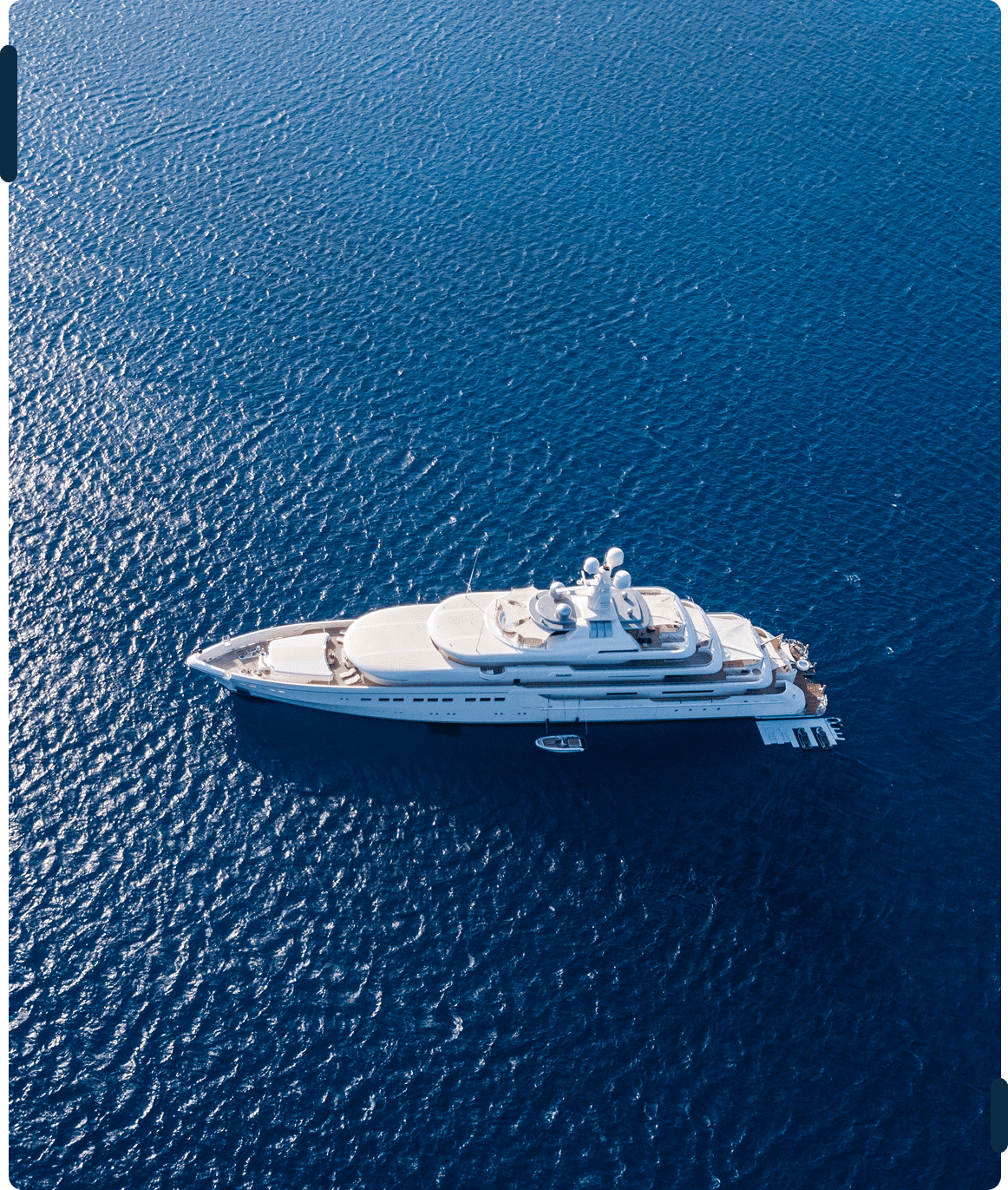 Luxury yacht sailing on calm blue ocean.